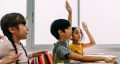 hands raised in classroom 767x418